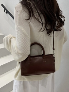 Retro dark brown leather crossbody bag with top handle and embossed fashion logo
