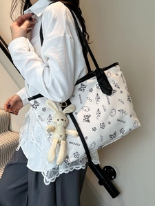 White graffiti canvas tote bag with black handles and cute plush rabbit keychain