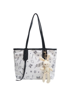 White tote bag with black minimalist graffiti illustrations and a cute rabbit charm