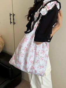 Floral canvas tote bag with pink roses and black ruffle trim for women's spring fashion