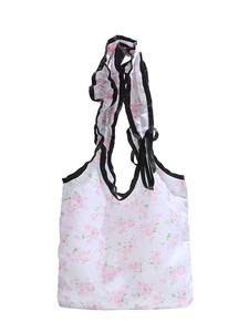 Floral canvas shoulder bag with pink blossom patterns and black ruffle strap details