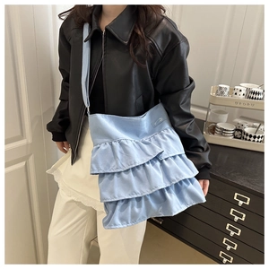 Detail of light blue ruffled tote bag with three-tier frills and wide shoulder strap