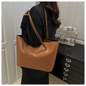 Macro detail of large caramel brown leather tote bag with smooth texture for daily commute