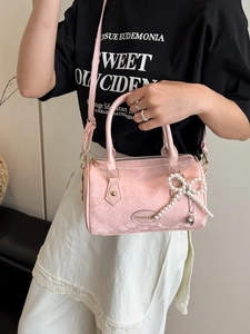 Pink faux snakeskin Boston bag with pearl bow charm and detachable strap for women