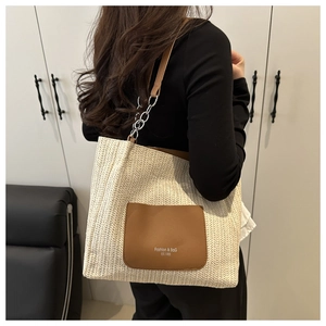 Detail of PP woven tote bag featuring a leather pocket and metal chain strap