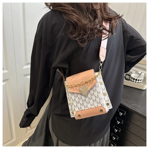 Detailed back view of cream shoulder bag with pink trim and wide crossbody strap