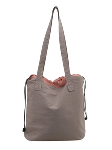 Minimalist grey canvas tote bag with drawstring closure and contrasting pink interior lining