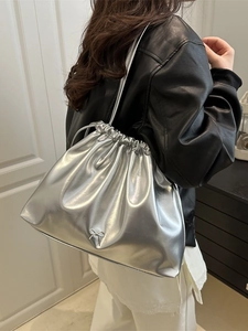 Silver metallic drawstring tote bag with a bow detail, stylish shoulder bucket bag style