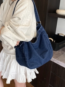 Large dark blue denim messenger bag with adjustable shoulder strap for casual wear