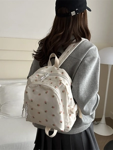 Mini floral printed backpack in cream white for girls with adjustable straps and front pocket