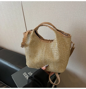 Detailed straw weave texture of a beige bucket bag with brown faux leather handles