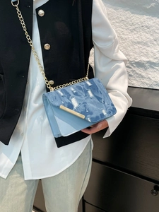 Chic light blue denim shoulder bag with gold chain strap and stylish distressed texture