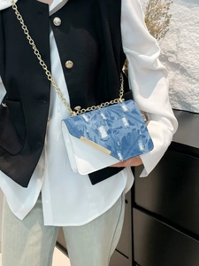 Blue denim and white leather shoulder bag with gold chain and distressed fringe details