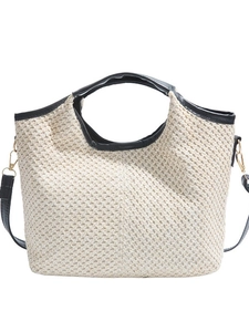 Chic beige woven straw tote bag with black leather trim and gold metal buckles