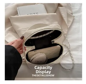 Interior detail of quilted chain bag showing capacity for phone and cosmetics