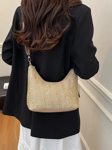 Fashionable beige straw hobo bag with leather strap shown as shoulder bag for women