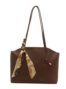 Brown faux leather tote bag with white contrast stitching and a patterned silk scarf