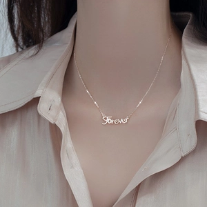 Elegant s925 silver Forever letter necklace with zircon pavé on a pink silk blouse