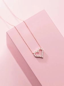 Detailed close-up of S925 sterling silver heart necklace with sparkling pavé zircons