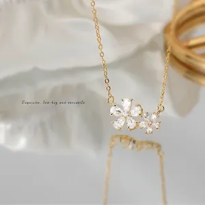 Minimalist gold double cherry blossom necklace with sparkling zircon petal pendant