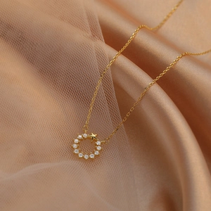 Elegant 925 silver gold star and pavé circle pendant necklace on silk fabric background