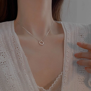 Elegant 925 sterling silver star circle necklace worn by model on white lace top