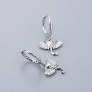 Macro shot of S925 sterling silver elephant drop earrings with detailed metal texture