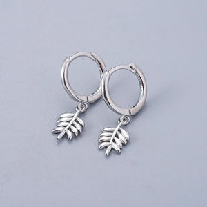 Detailed close-up of S925 sterling silver leaf hoop earrings with fine texture and hallmark