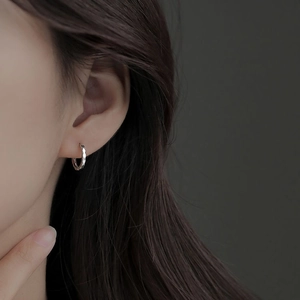 Close-up of silver geometric faceted ear cuff showing unique reflective metal texture