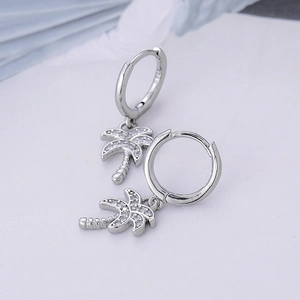 Detailed macro view of S925 silver coconut tree earrings with sparkling white zircons