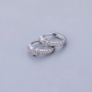 Elegant silver star hoop earrings with clear cubic zirconia pavé on a grey background