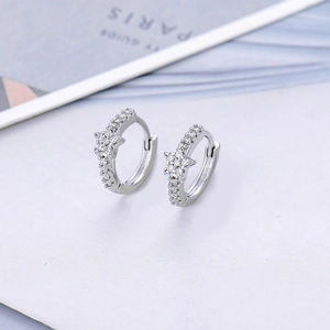 Detailed view of silver star hoop earrings with micro-set rhinestones on white card