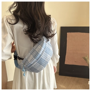 Light blue plaid corduroy saddle bag worn as a crossbody on a casual white dress