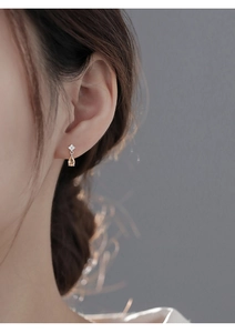 Close-up of champagne teardrop zircon stud earrings on model for elegant style