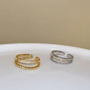 Double-layered gold and silver ear cuffs with zircon pavé and beaded textures