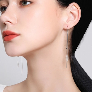 Elegant S925 sterling silver leaf tassel earrings worn by a model for a slender facial look