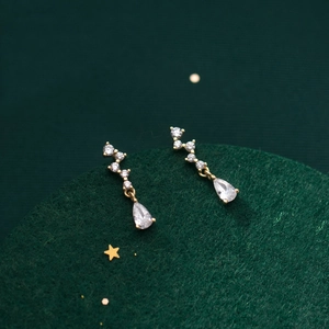 Elegant gold drop earrings with line-arranged round zircons and pear-shaped stone