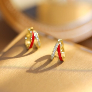 Fashionable gold earrings with red enamel hoops and pave diamonds in a geometric design