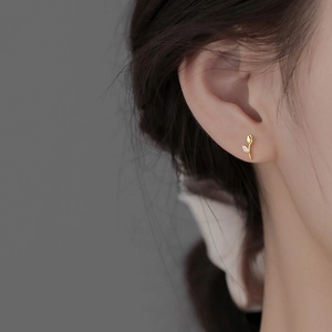 Elegant gold tulip stud earrings with marquise zircon on model for women