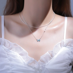Detail of S925 silver double-layered necklace featuring a gradient butterfly pendant