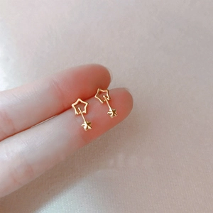 Polished gold double star drop earrings featuring a hollow geometric shooting star design