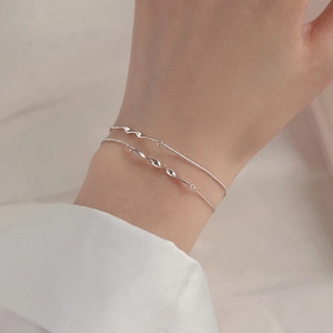 Minimalist S925 sterling silver Mobius double-layer bracelet shown on a woman wrist
