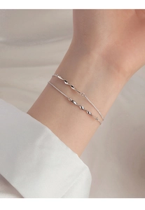 Close-up of S925 sterling silver Mobius double-layered bracelet with twisted metal bar