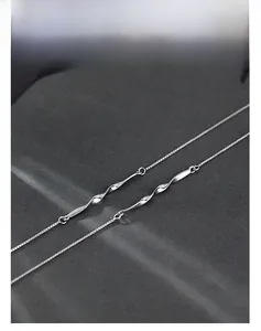 Macro shot of silver Mobius double-layer bracelet with sleek twisted metal bars