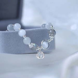 Detail of beaded bracelet with cat's eye stone, labradorite and crystal sphere pendant