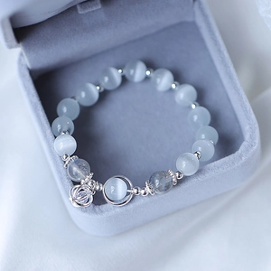Cat's eye bead bracelet with moon pendant and silver hollow ball in a jewelry box