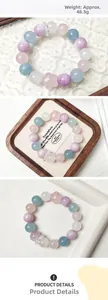 Detailed view of 48.5g pastel crystal bead bracelet with a pink star charm on wood