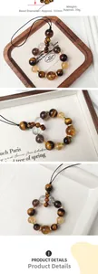 Detail of 13mm gold tiger eye and clear crystal phone charm beads with macro specs