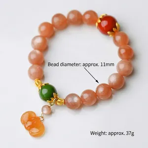 Natural 11mm Sunstone and Red Rabbit Hair Jasper beaded bracelet with carved charm