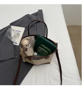 Interior view showing the large capacity of the beige tote bag with daily essentials